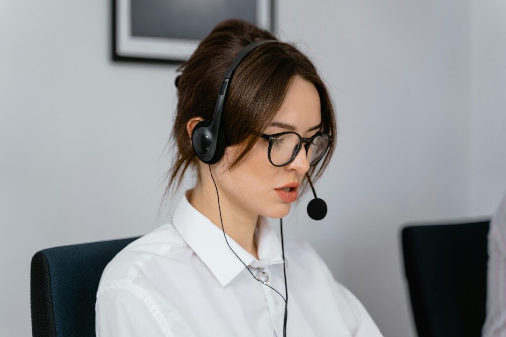 A Pretty Woman Wearing a Headset and Eyeglasses